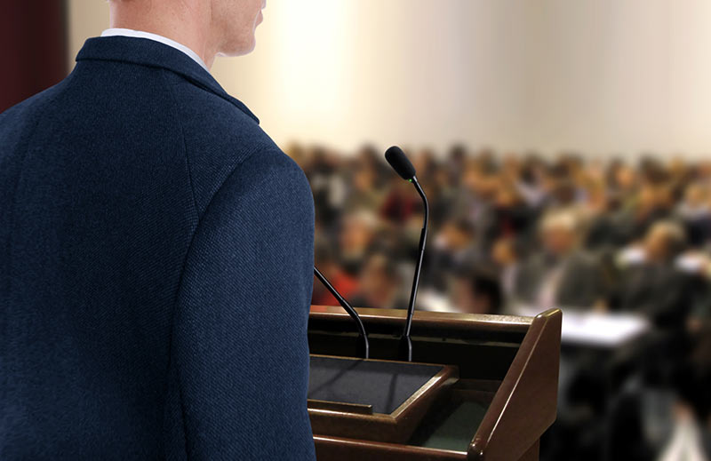 Person speaking in front of audience
